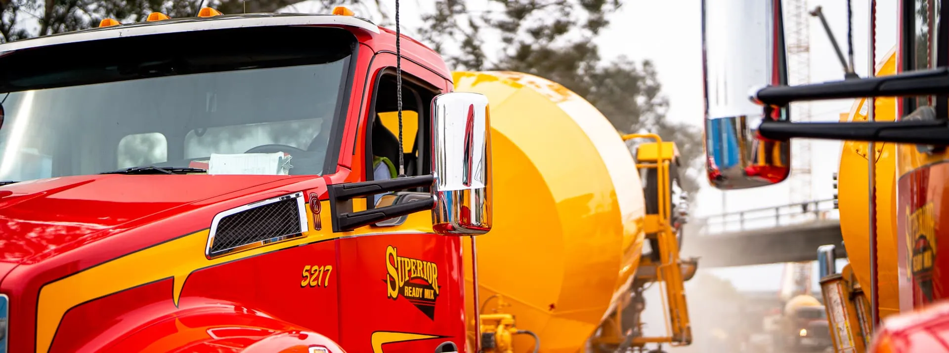 Close-up of a Superior Ready Mix concrete truck cab and mixer drum with the Superior Ready Mix logo visible, representing the Southern California ready mix concrete and construction materials fleet.